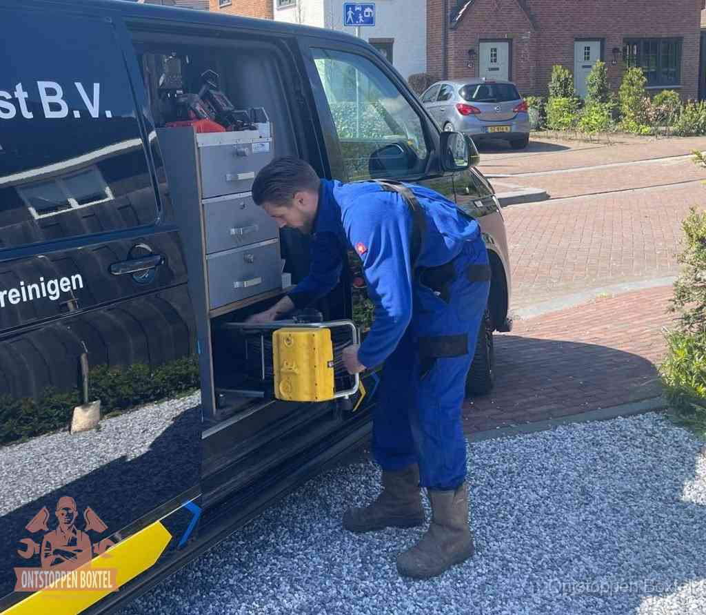 Een monteur pakt apparatuur uit de bedrijfsbus voor service aan huis, het moment om een professional in te schakelen in Boxtel