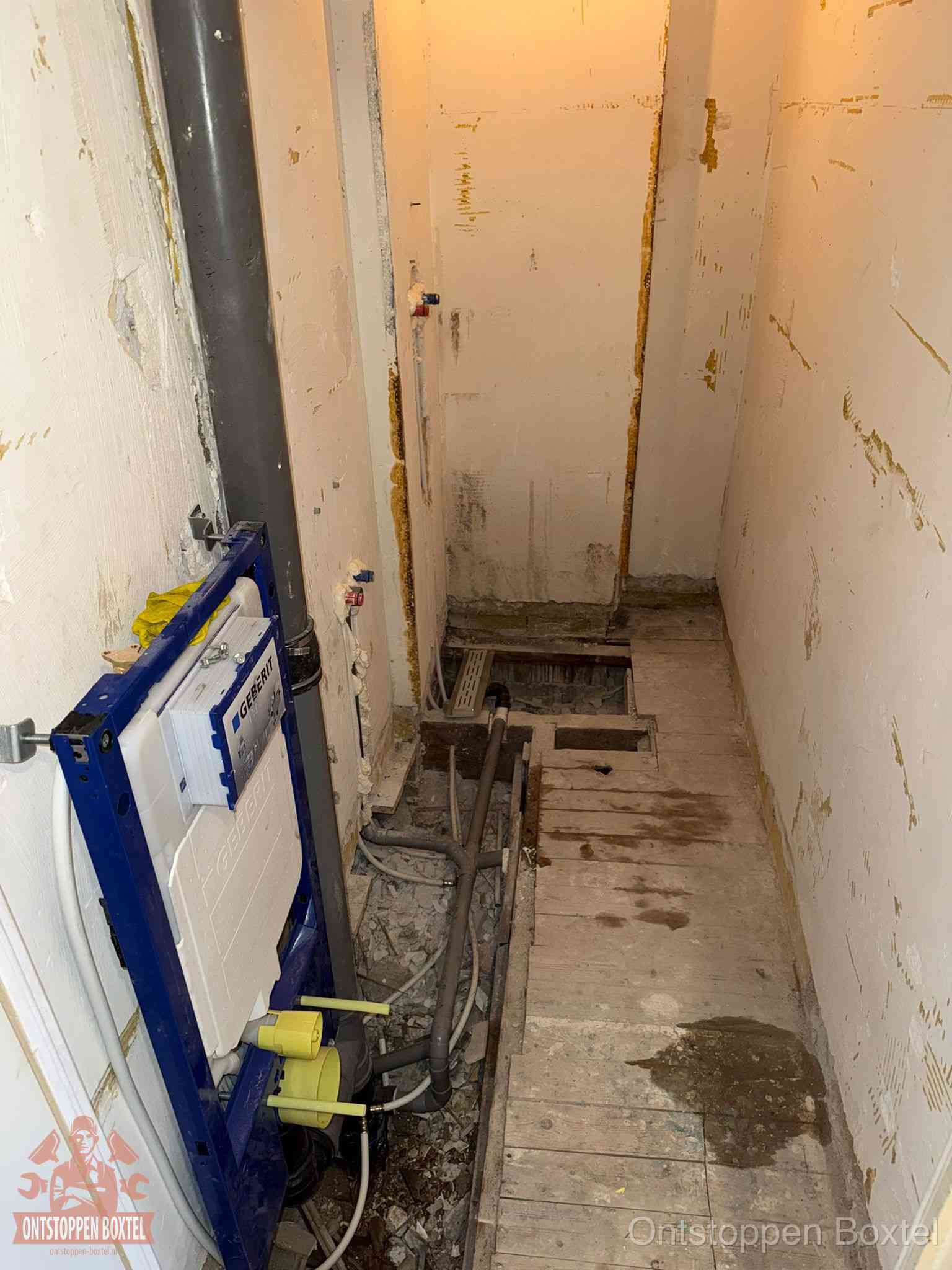 Een opgebroken toiletruimte tijdens renovatie met een Geberit inbouwreservoir en blootliggende oude afvoerleidingen, typisch voor oudere woningen in Boxtel